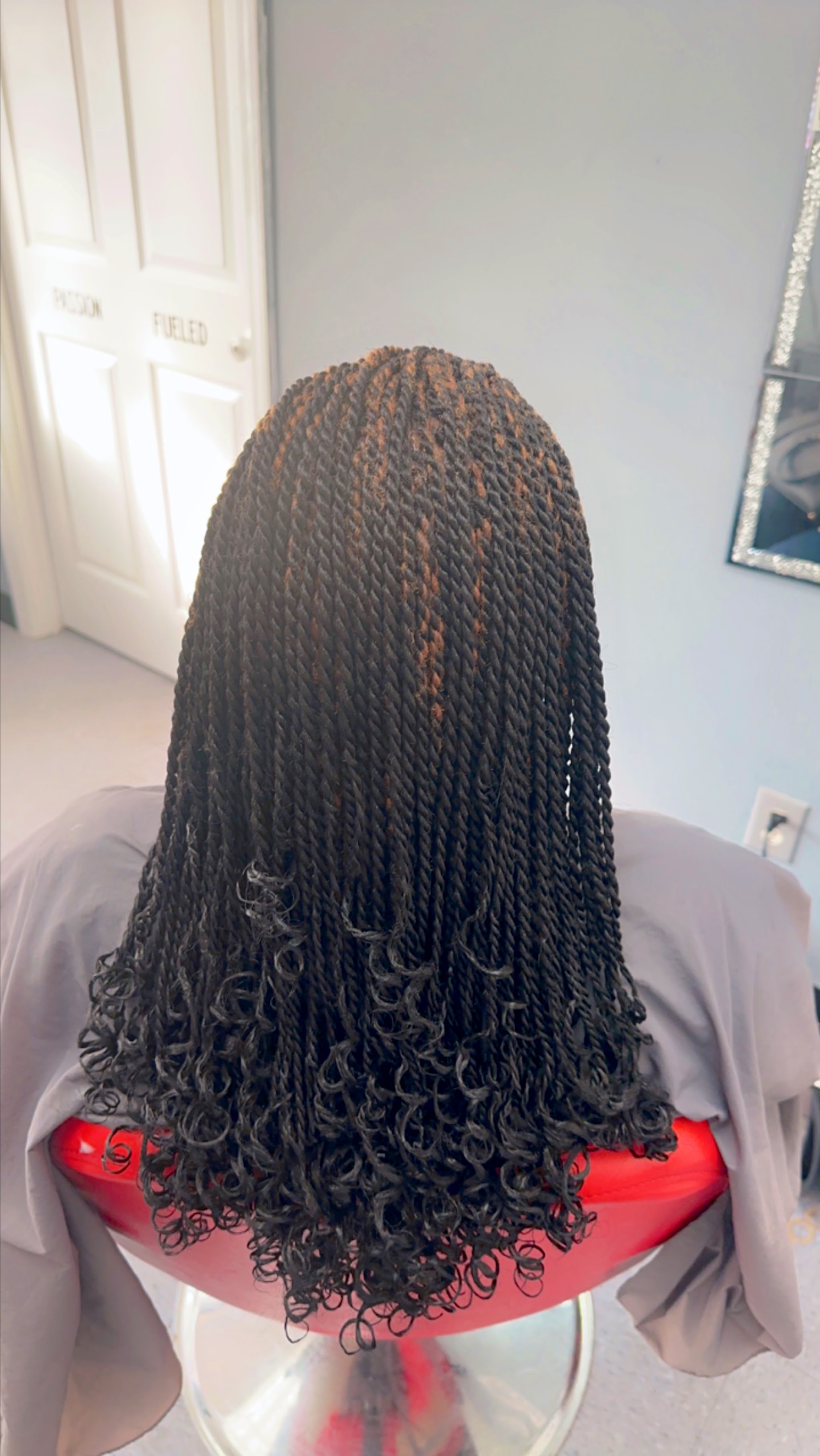 Shoulder-length braids with curly ends